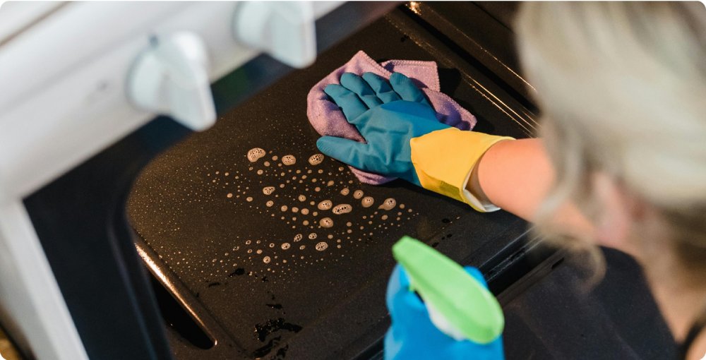 Deep cleaning service removing grease from an oven.